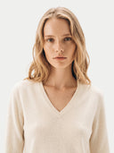 The Cashmere Deep V-Neck Sweater in White, shown worn.