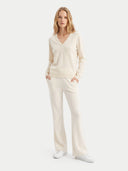 The Cashmere Deep V-Neck Sweater in White, shown worn.