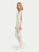 The Cashmere Deep V-Neck Sweater in White, shown worn.