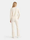 The Cashmere Deep V-Neck Sweater in White, shown worn.