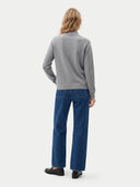 The Cashmere Mock Neck Sweater in light gray, shown worn.