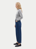 The Cashmere Mock Neck Sweater in light gray, shown worn.