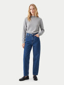 The Cashmere Mock Neck Sweater in light gray, shown worn.