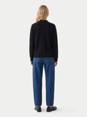 The Cashmere Mock Neck Sweater in Black, shown worn.