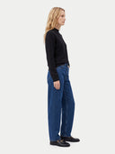 The Cashmere Mock Neck Sweater in Black, shown worn.