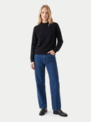 The Cashmere Mock Neck Sweater in Black, shown worn.