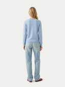 Women's Light Blue Cashmere Crewneck Sweater worn by model, back view on white background