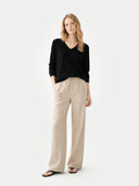 Women's Black Cashmere V-Neck Sweater worn by model, front view on white background