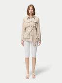 Woman wearing a beige jacket with multiple pockets on a white background #color_dusty-beige