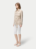 Woman wearing a beige jacket with multiple pockets on a white background #color_dusty-beige