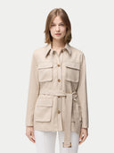 Woman wearing a beige jacket with multiple pockets on a white background #color_dusty-beige