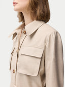 Woman wearing a beige jacket with multiple pockets on a white background #color_dusty-beige