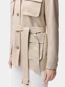 Woman wearing a beige jacket with multiple pockets on a white background #color_dusty-beige