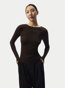 A woman in a fitted black long-sleeve cashmere top