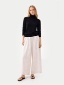 Women's Classic Cashmere Turtleneck Sweater Black worn by model, front view, on white background