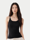 Woman wearing a black tank cashmere top against a white background #color_graphite-black