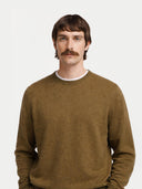 Man wearing a brown cashmere sweater on a white background. #color_muted-green