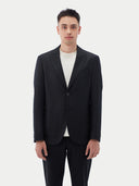 Men's Black single-breasted cashmere blazer worn by model, detail view on white background