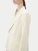Women's White single-breasted cashmere blazer worn by model, side view on white background