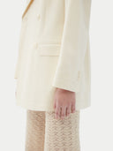 Women's White single-breasted cashmere blazer worn by model, side view on white background