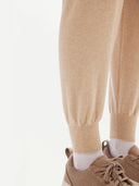 Women's Cashmere Cuffed Jogger Beige  worn by model, detail view on white background