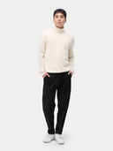 A man wearing a white turtleneck cashmere sweater with long sleeves. #color_off-white