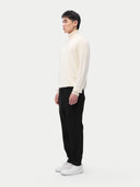 A man wearing a white turtleneck cashmere sweater with long sleeves. #color_off-white