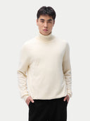 A man wearing a white turtleneck cashmere sweater with long sleeves. #color_off-white