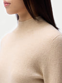 Essential Organic Cashmere Mock Neck Pullover Beige worn by model, detail view, on white background