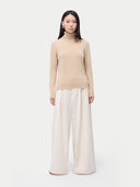 Cashmere Turtleneck Sweater Beige worn by model, front view, on white background