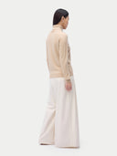 Cashmere Turtleneck Sweater Beige worn by model, back view, on white background
