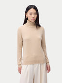 Cashmere Turtleneck Sweater Beige worn by model, detail view, on white background