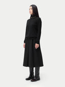 Cashmere Turtleneck Sweater Black worn by model, side view, on white background