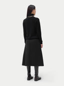 Cashmere Turtleneck Sweater Black worn by model, back view, on white background