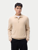 Men’s beige cashmere polo sweater worn by model, detail view on white background