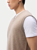 Men’s taupe cashmere vest worn by model, detail view, on white background
