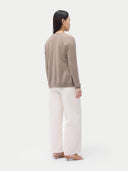 Cashmere Crew Neck Button Cardigan Taupe worn by model, back view, on white background
