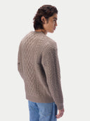 Back view of a man in a taupe cable-knit cashmere jumper