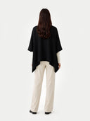 Women's Boat-Neck Cashmere Poncho Black worn by model, back view on white background
