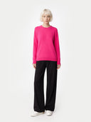 Women's Magenta Pink Cashmere Crewneck Sweater worn by model, front view on white background 