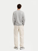 Man wearing a gray cashmere sweater on a white background. #color_steel_silver