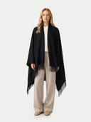 Cashmere Large Blanket with Fringe Black   worn by model, front view on white background