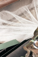 A web of cashmere fibre stretched across a carding machine
