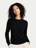 Women's Black Cashmere Crewneck Sweater worn by model, detail view on white background