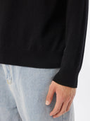 Men's Black Crewneck Cashmere Sweater worn by model, detail view on white background
