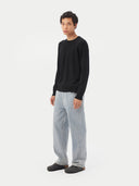 Men's Black Crewneck Cashmere Sweater worn by model, side view on white background