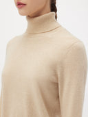 Women's Beige Cashmere Basic Turtle Neck Sweater worn by model, detail view on white background