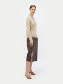 Women's Beige Cashmere Basic Turtle Neck Sweater worn by model, side view on white background