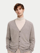 Man wearing a gray cashmere cardigan over a beige turtleneck on a light background #color_steel-silver