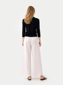 Women's Classic Cashmere Turtleneck Sweater Black worn by model, back view, on white background